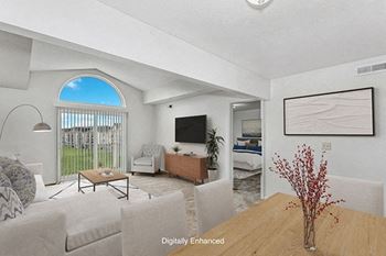 Living room with a cathedral ceiling at Orchard Lakes Apartments in Toledo, OH